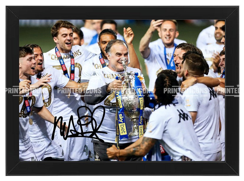 Signed (printed photo) of Marcelo Bielsa managing Leeds United. He is lifting the 2020 Championship trophy. A printed autograph taken from a genuine, certified (certificate of authenticity) autograph. A stunning signature. The print is available in a range of sizes with various framing options available.  Marcelo Bielsa is famous for sitting on his iconic blue bucket. 