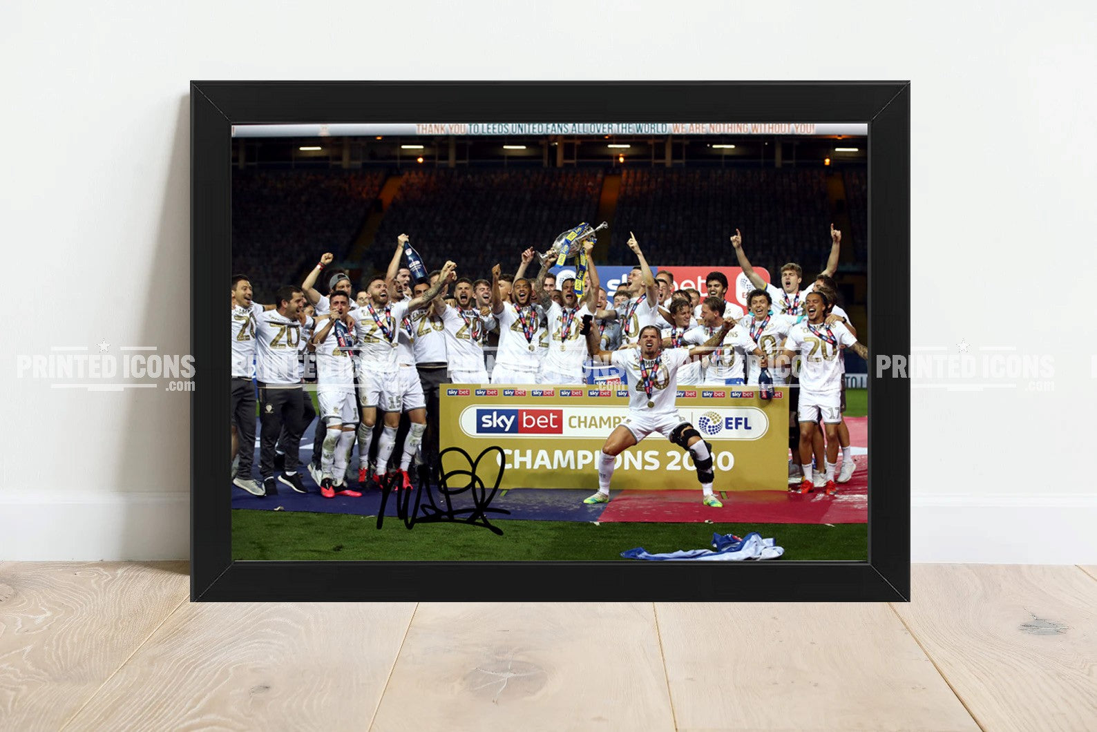 Signed (printed photo) of the 2020 Leeds United Championship squad with the league  trophy. A printed autograph taken from a genuine, certified (certificate of authenticity) autograph. A stunning signature. The print is available in a range of sizes with various framing options available.  Marcelo Bielsa is famous for sitting on his iconic blue bucket.