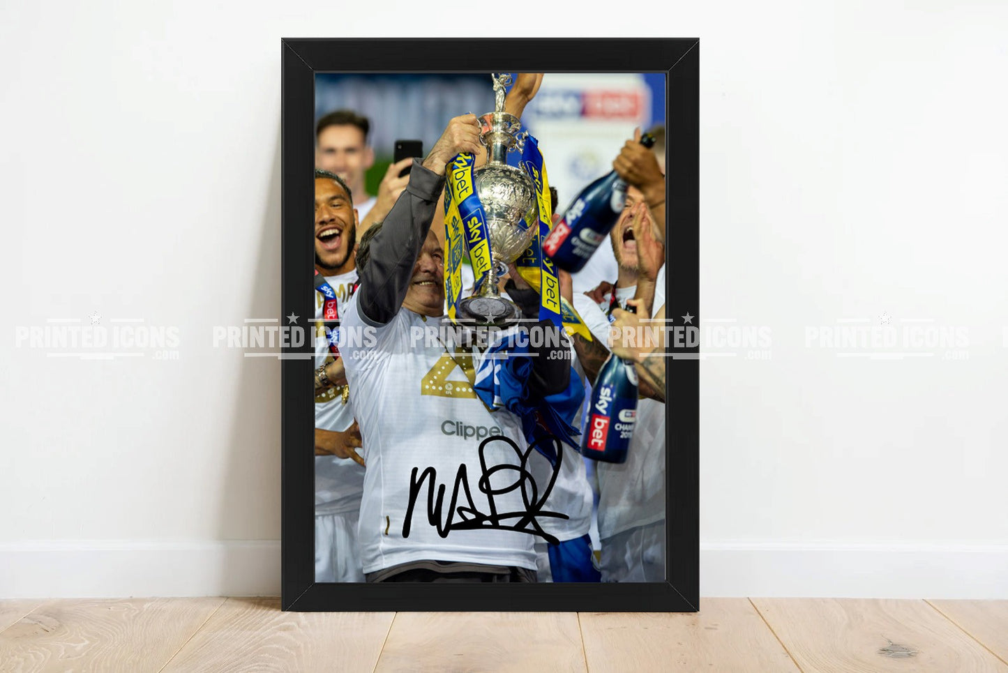 Signed (printed photo) of Marcelo Bielsa managing Leeds United. He is lifting the 2020 Championship trophy. A printed autograph taken from a genuine, certified (certificate of authenticity) autograph. A stunning signature. The print is available in a range of sizes with various framing options available.  Marcelo Bielsa is famous for sitting on his iconic blue bucket. 