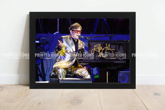 Signed (printed photo) of Elton John. A printed autograph taken from a genuine, certified (certificate of authenticity) autograph. A stunning signature. The print is available in a range of sizes with various framing options available. Yellow Brick Road final tour.