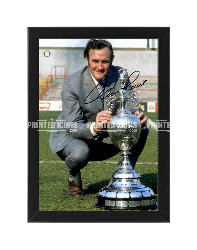 Signed (printed autograph) photo of Don Revie with the 1974 League Cup.  A printed autograph taken from a genuine, certified (certificate of authenticity)  autograph. A stunning signature. The print is available in a range of sizes with various framing options available. A framed photo version is the perfect gift for any fan.