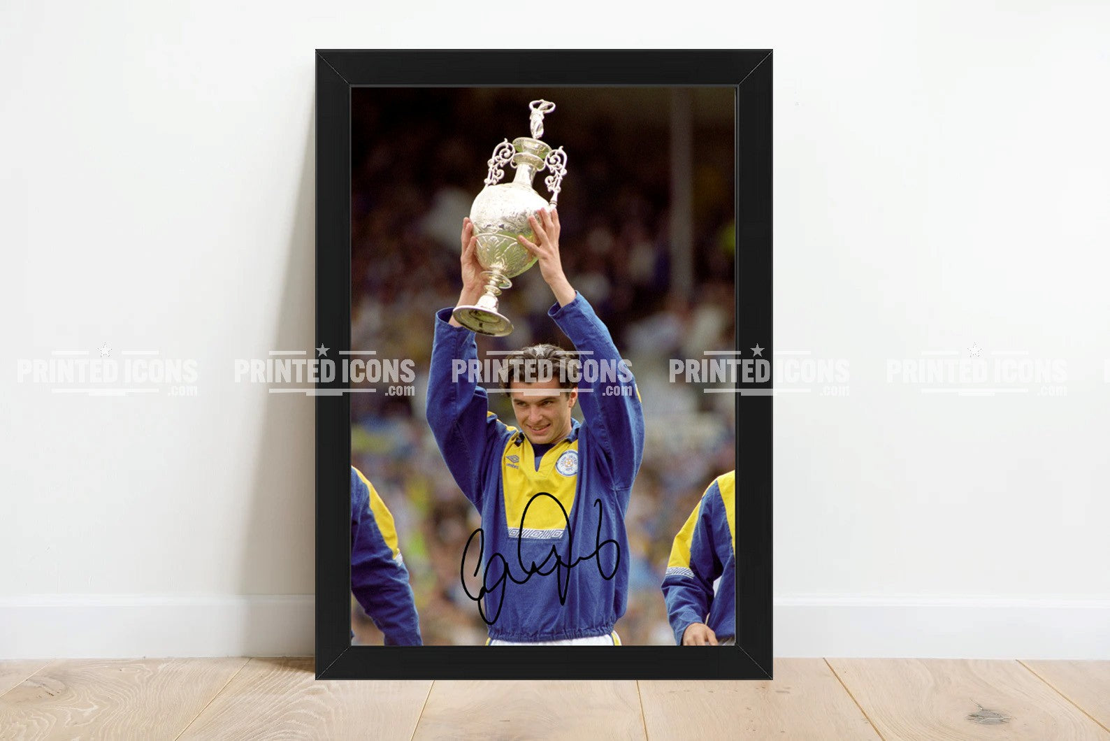 Signed (printed autograph) photo of Gary Speed holding the 1992 First Division Champions trophy for Leeds United.  A printed autograph taken from a genuine, certified (certificate of authenticity)  autograph. A stunning signature. The print is available in a range of sizes with various framing options available. A framed photo version is the perfect gift for any fan.