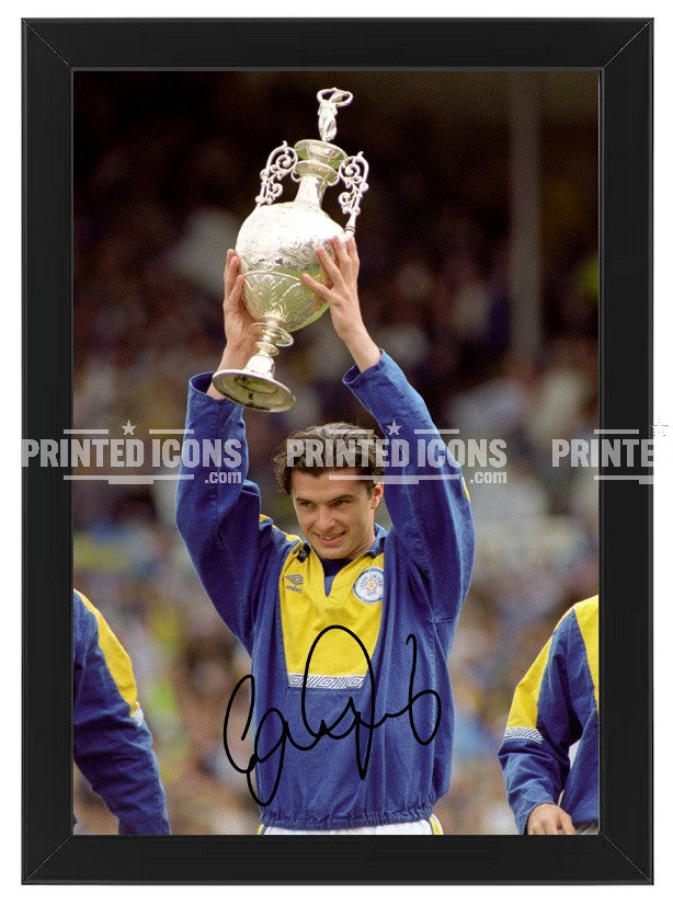 Signed (printed autograph) photo of Gary Speed holding the 1992 First Division Champions trophy for Leeds United.  A printed autograph taken from a genuine, certified (certificate of authenticity)  autograph. A stunning signature. The print is available in a range of sizes with various framing options available. A framed photo version is the perfect gift for any fan.