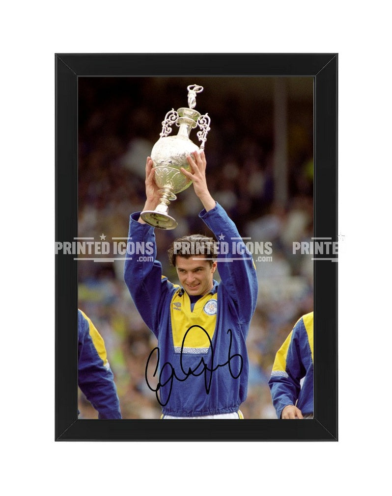 Signed (printed autograph) photo of Gary Speed holding the 1992 First Division Champions trophy for Leeds United.  A printed autograph taken from a genuine, certified (certificate of authenticity)  autograph. A stunning signature. The print is available in a range of sizes with various framing options available. A framed photo version is the perfect gift for any fan.