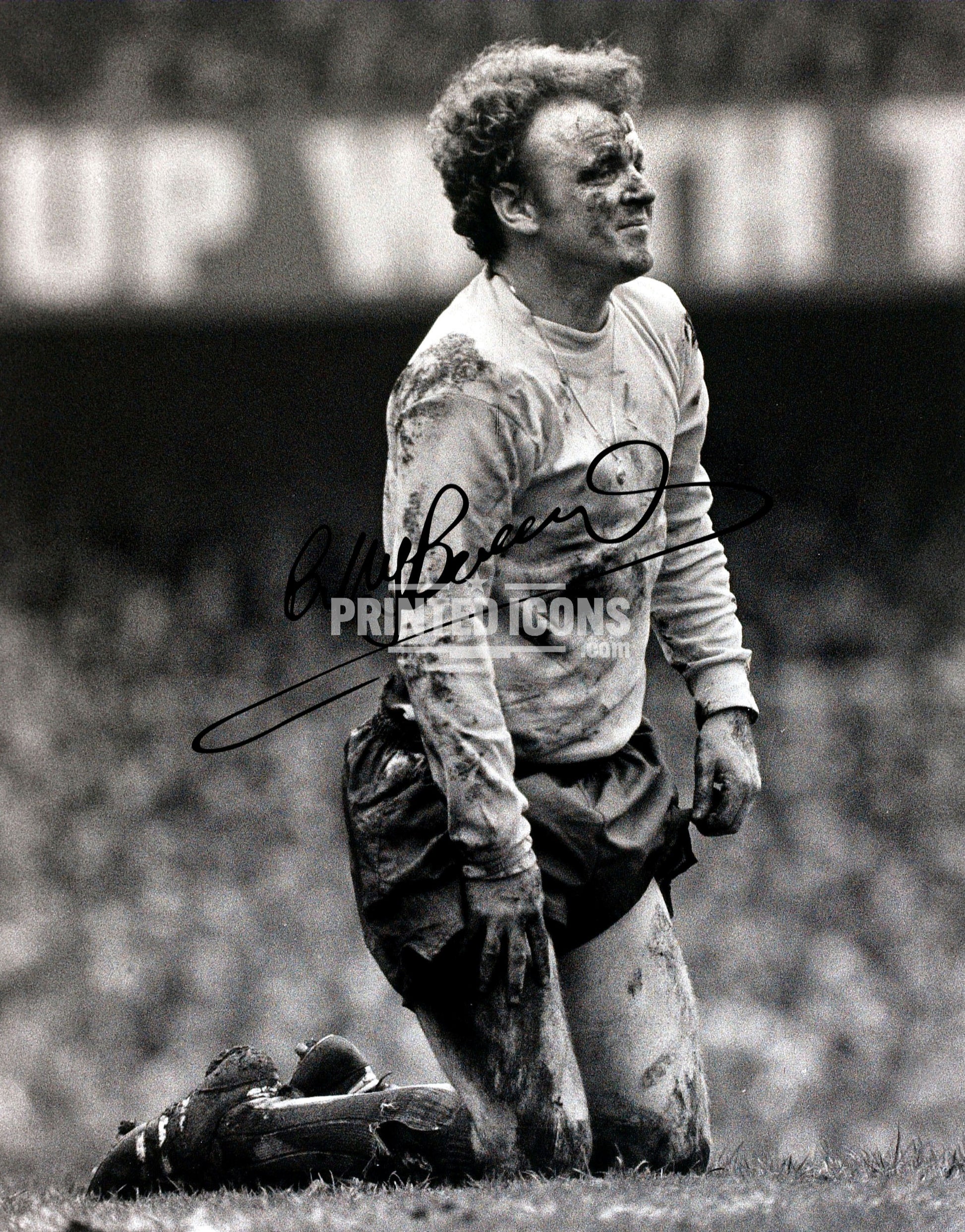 Billy Bremner in the mud signed photo. A printed autograph (from a certified original) on a Leeds United photo. Framing Available. A great gift for a Leeds United fan.