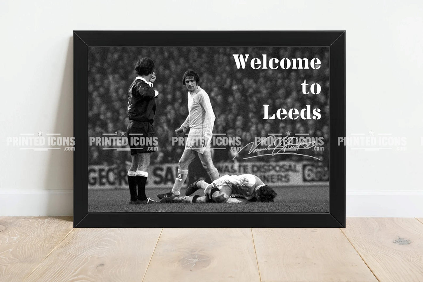 Signed (printed autograph) of Norman Hunter, Leeds United, after the iconic tackle on Franny Lee. The image is captioned 'Welcome to Leeds'. A printed autograph taken from a genuine, certified (certificate of authenticity)  autograph. A stunning signature. The print is available in a range of sizes with various framing options available. A framed photo version is the perfect gift for any fan.