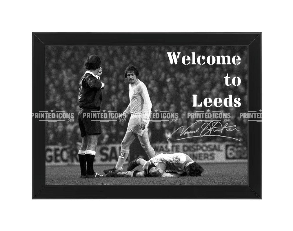 Signed (printed autograph) of Norman Hunter, Leeds United, after the iconic tackle on Franny Lee. The image is captioned 'Welcome to Leeds'. A printed autograph taken from a genuine, certified (certificate of authenticity)  autograph. A stunning signature. The print is available in a range of sizes with various framing options available. A framed photo version is the perfect gift for any fan.