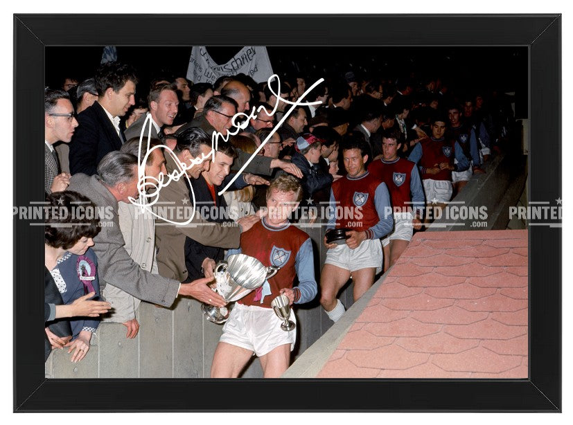 Bobby Moore West Ham signed-style football print displayed in a black frame, celebrating the Hammers’ famous 1964 FA Cup victory.