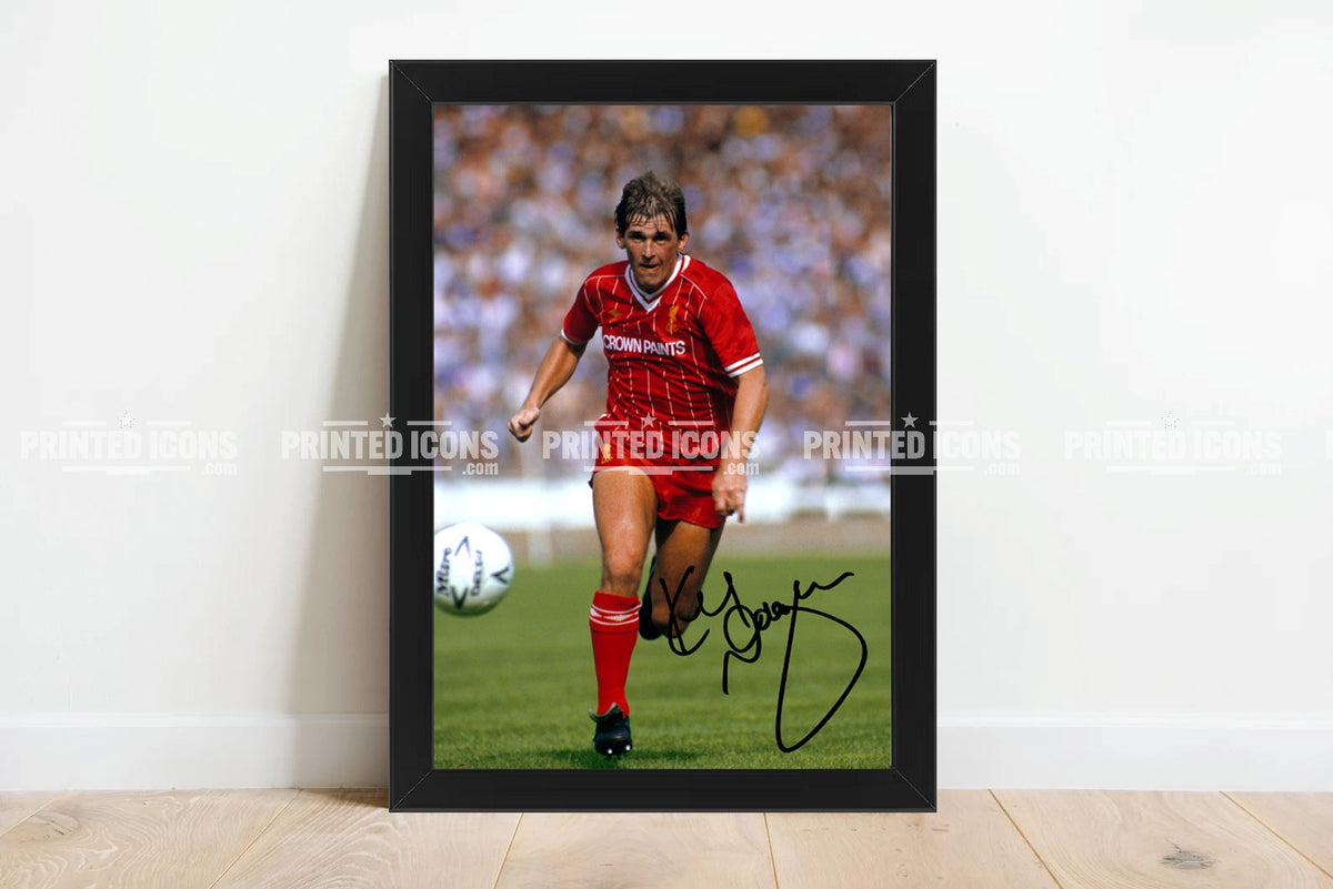 Framed Kenny Dalglish signed Liverpool FC retro football print displayed against white wall
