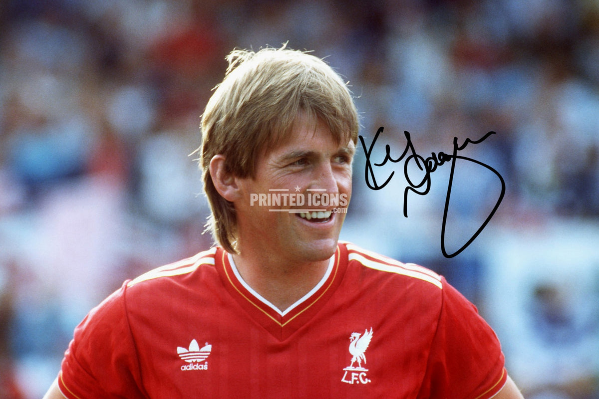 Kenny Dalglish smiling in Liverpool Adidas shirt with printed autograph
