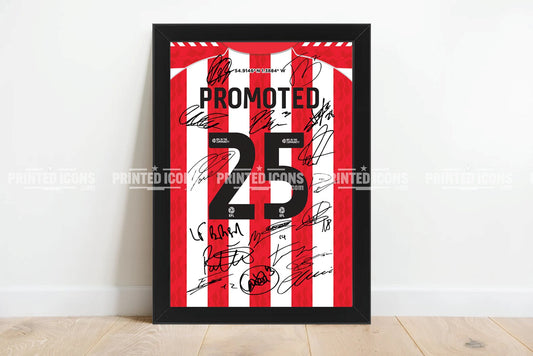 A My Store 2025 Sunderland Promotion Multi Signed Print Photo, featuring squad autographs and “PROMOTED 23,” displayed against a white wall on a wooden floor.